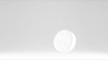 Effervescent tablet in water with bubbles. White medicine pill in with bubbles on white background. video
