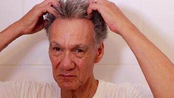 Slow Motion of a Older Mature Man doing a self-Massage on the top of his head. video