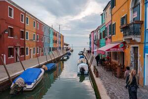 Tranquil Daytime Scene of Colorful Buildings Along Canal in Burano, Italy photo