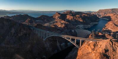 Hoover Dam on the Colorado River straddling Nevada and Arizona at dawn from above. photo