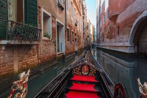 Serene Traditional Gondola on Venice Canal - Timeless Charm and Beauty of Summer photo