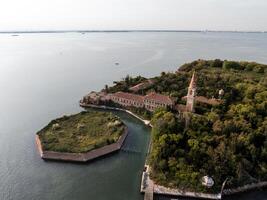 Aerial view of the plagued ghost island of Poveglia in the Venetian lagoon photo