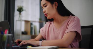 Portrait of Young woman typing work with laptop on a desk in home office. photo