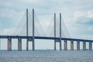 Oresund Bridge Connecting Copenhagen and Malmo on an Overcast Day photo