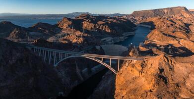 Hoover Dam on the Colorado River straddling Nevada and Arizona at dawn from above. photo