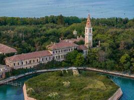 Aerial view of the plagued ghost island of Poveglia in the Venetian lagoon photo