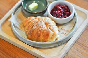 croissant , French croissant or French bread with strawberry dressing and butter photo