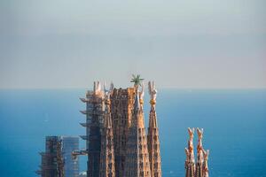 CloseUp View Sagrada Familia Spires in Barcelona Against Sea Backdrop photo