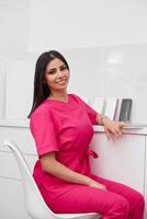 Beautiful doctor cosmetologist in a private office photo