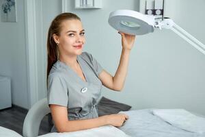 Portrait of a cosmetologist with a dermapen device. photo