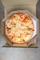 a box of pizza ,shrimp pizza photo