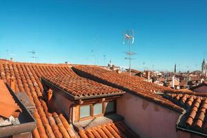 Tranquil Venice Serene rooftop view of the historic city with clear blue sky. photo