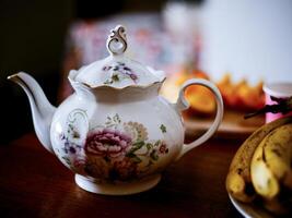 A ceramic tea pot on te table photo