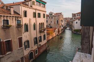 Gondolas Floating on Charming Canal with Vibrant Venetian Architecture photo
