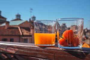 City View Balcony Elegant Orange Juice and Strawberries Overlooking Iconic Venetian Landmarks photo
