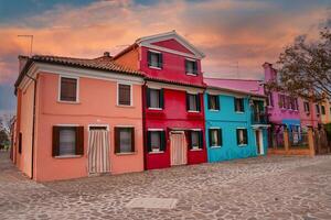 Vibrant Venetian Row of Colorful Houses on Cobblestone Street in Venice, Italy photo