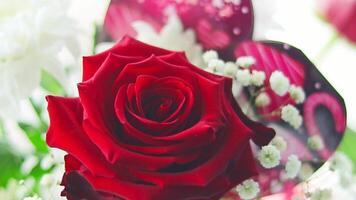 Slow motion footage of the valentines bouquet with beautiful, colorful flowers and post card. Celebration video