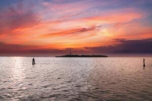 Tranquil sunset over calm water with small island, aerial view of picturesque natural landscape photo