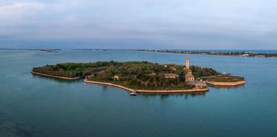 Aerial view of the plagued ghost island of Poveglia in the Venetian lagoon photo