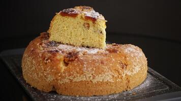 cooked sweet biscuit with dried apricots and nuts inside isolated on black background video