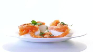 halves of boiled eggs with pieces of salted salmon isolated on white background video