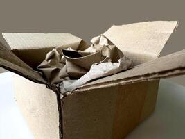 Cartoon box full of paper. Cardboard box with wrapping paper inside, recycling concept. photo