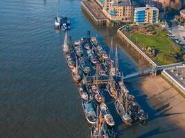 Yachts and boats docked by the bank of the river Thames. photo