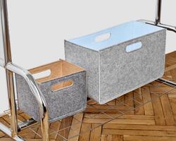 Grey felt storage bins placed on chrome shelving unit over herringbone wood floor photo