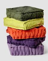 Stack of colorful decorative linen cushions against neutral background photo