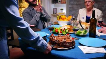 Young woman giving her husband a slice of cake at family dinner. video