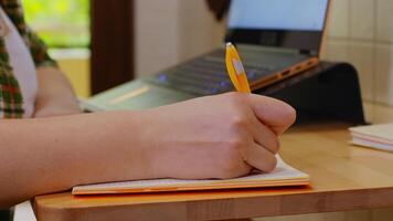 Woman taking notes while working from home during coronavirus isolation. video