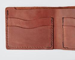 Open brown leather wallet with pockets for cards and drivers license photo