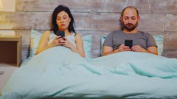 Zoom in shot under the blanket in bed using smartphone before sleeping. video