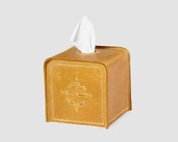 Tan leather tissue box cover with compass embossing on white photo