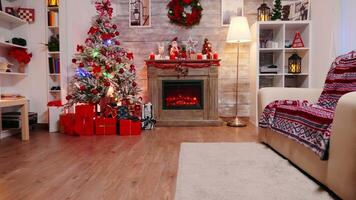 Zoom in shot of fireplace burning in a room decorated for christmas celebration. video