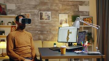 Male engineer working in his home office on a new technology for gears system wearing a virtual reality headset. video