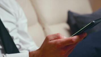 Close up shot of man hand using a smartphone in the living room. video