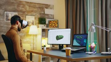 Engineer with virtual reality headset at his desk during night time working on a new technology for turbines. video