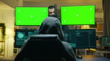 Team of hackers using computer with green screen mockup to steal secret information from the government. video