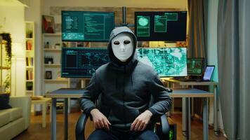 Cyber criminal wearing a white mask using augmented reality to steal secret information. video