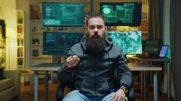 Bearded hacker doing hand gestures using augmented reality while breaking a firewall. video