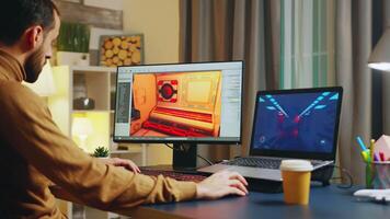 Male game developer typing on keyboard while developing a new level of the game. video