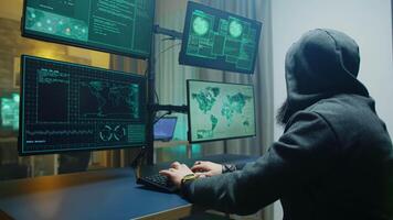 Side view of masked hacker writing a dangerous malware. Cyber criminal. video