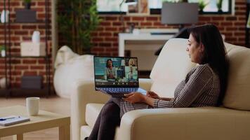 Remote worker talks with board of directors during videocall business meeting from home office. Teleworker speaks in remote videoconference telework call, receiving feedback from management video