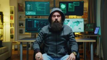 Bearded hacker wearing a hoodie using augmented technology to break government firewall. video