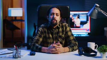 POV of influencer filming himself in home studio, doing daily vlog for internet subscribers. Caucasian media star waving towards camera, greeting audience, doing live streaming broadcast for fans video