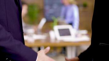 Close up of man and woman shaking hands in the office after a business agreement. video