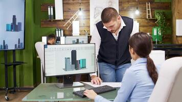 Construction engineer and female architect having a discussion about new office buildings. Architect holding building models. video