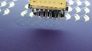 Modern sewing machinery in a fabric factory doing patterns. Embroidery equipment. video