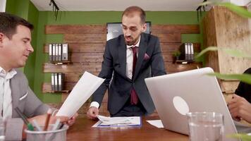 homme d'affaire dans costume avec la gestion équipe dans le conférence chambre. femme travail sur portable. video